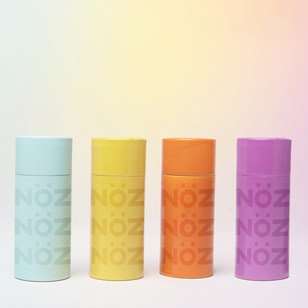 Front view of four Nözscreen bottles in the blue, yellow, orange, and purple colors